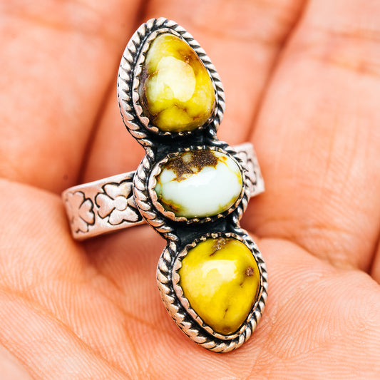 Sterling silver adjustable ring with three oval cabochons and cutout floral side band