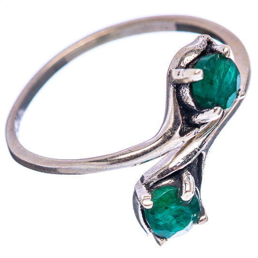 Sterling silver gemstone ring with two green stones, side view of curved band