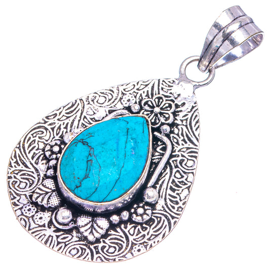 Turquoise teardrop pendant with detailed filigree frame, silver-tone bail for chain