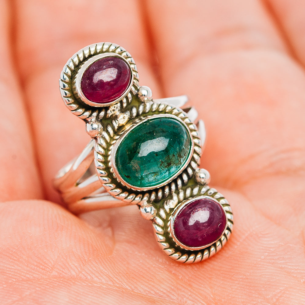 Sterling silver ring showing green oval center stone and two purple oval stones in beaded settings