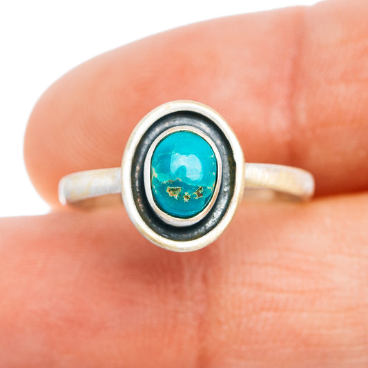 Sterling silver ring with oval turquoise cabochon and two-tone bezel