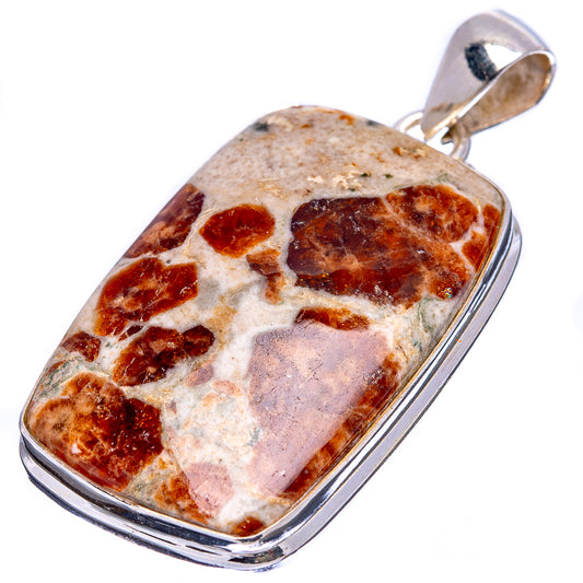 Sterling silver rectangular pendant with gemstone face, tan background and dark reddish inclusions