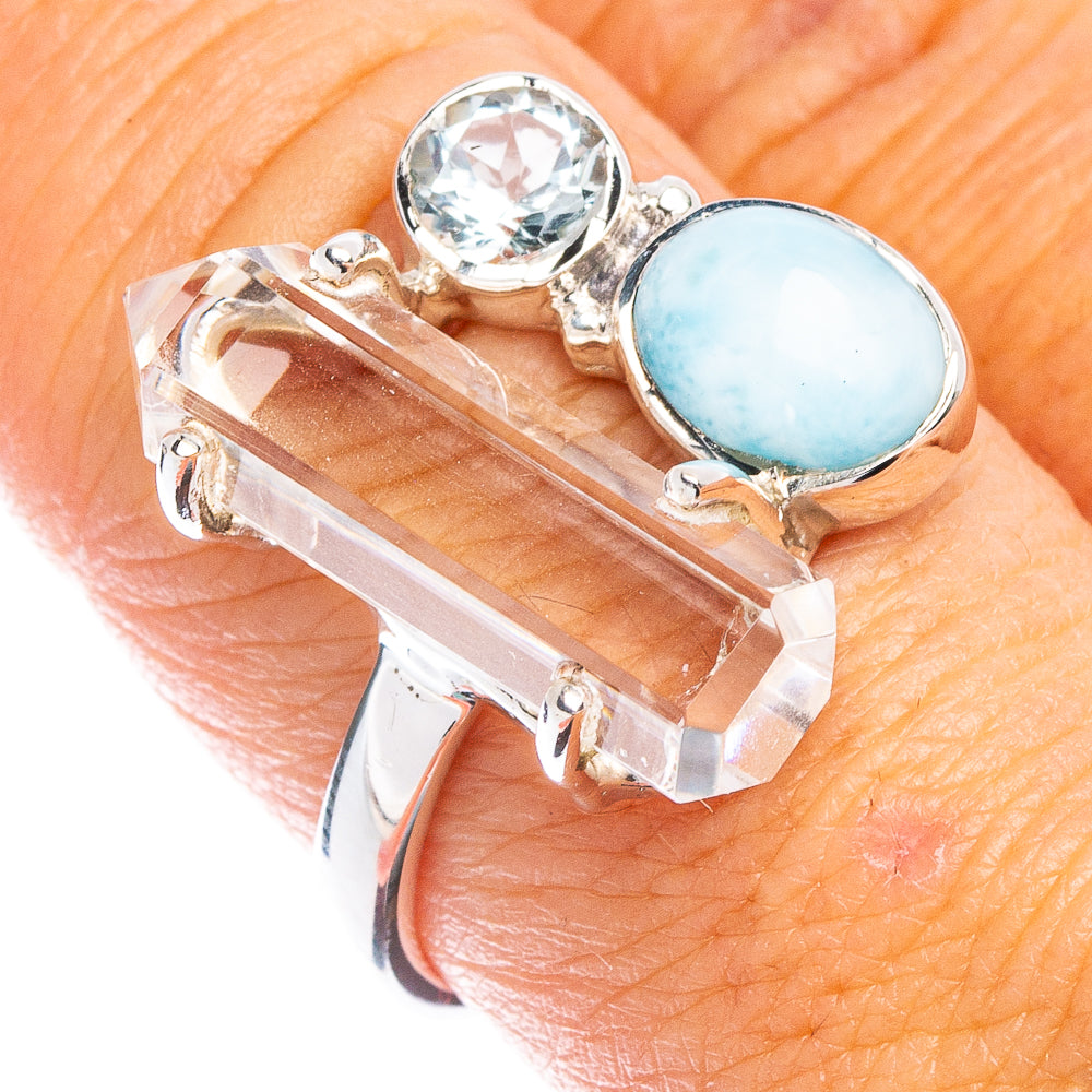 Sterling silver ring with round clear stone and oval light blue gemstone setting