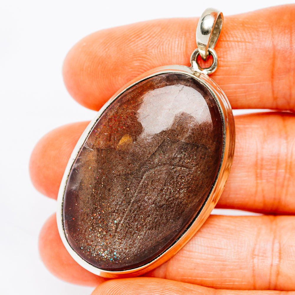 Oval druzy sunstone pendant in silver-tone bezel with loop bail, stone brown
