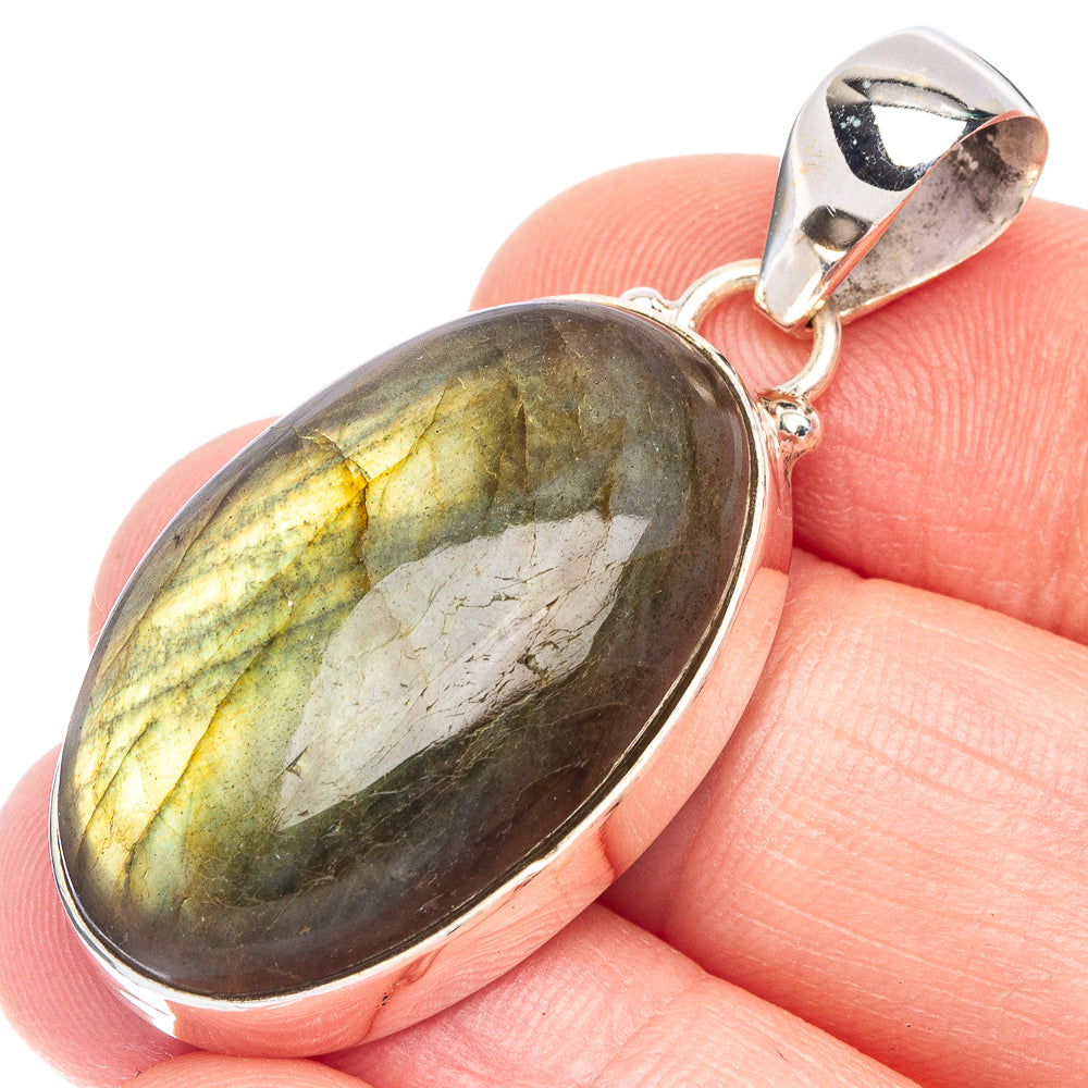 Labradorite pendant with oval gemstone and silver bezel, shown close-up on a bail