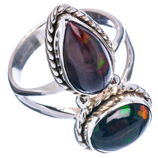 Sterling silver ring with two oval opal gemstones in an ornate twisted setting
