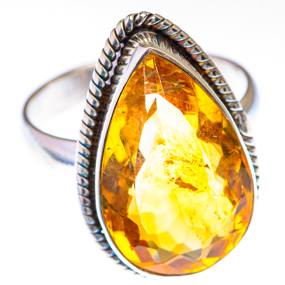 Sterling silver citrine teardrop ring with faceted center and braided rope band