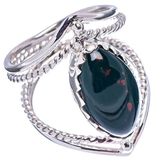 Sterling silver ring with oval dark cabochon and red speckles, openwork prong and rope band.