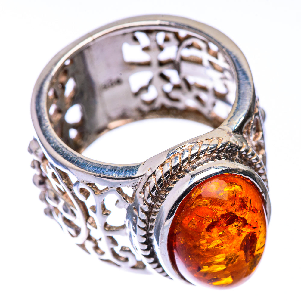 Oval amber cabochon ring with ornate silver filigree and round side motif, size 6.5