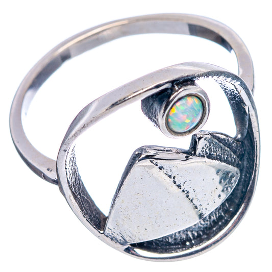 Sterling silver ring showing round lab opal bezel and openwork mountain heart setting