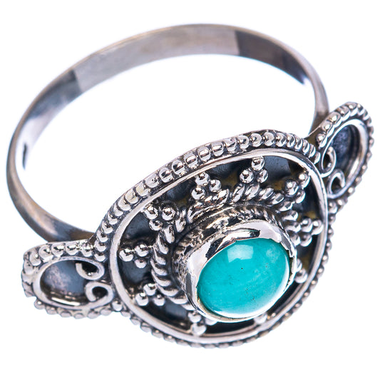 Sterling silver oval cabochon ring with turquoise stone and filigree bezel, side view