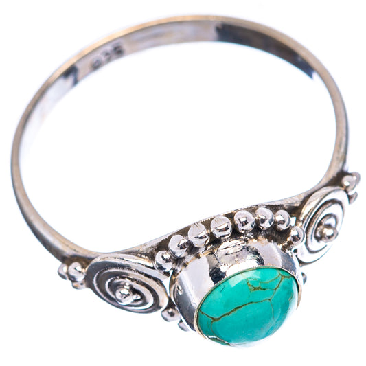 Sterling silver ring with oval turquoise stone and side swirl designs