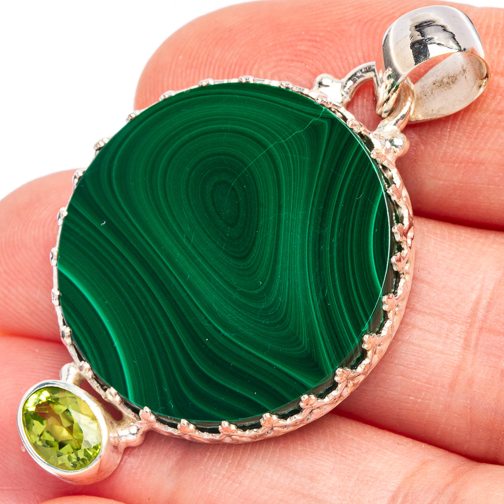 Round sterling silver pendant with green malachite center and small peridot charm