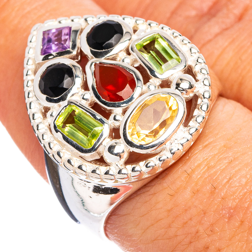 Sterling silver ring with oval bezel gemstones: purple, black, green, red, yellow.