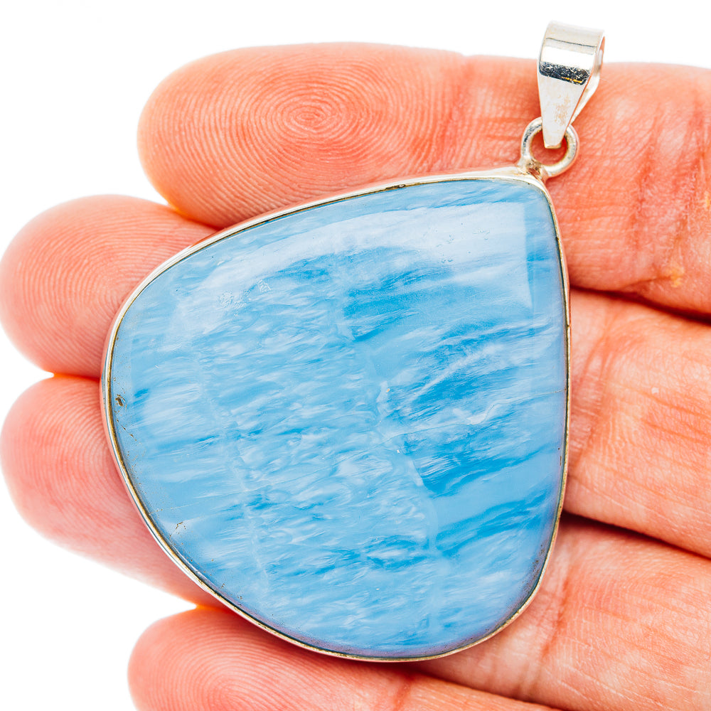Blue teardrop opal pendant in .925 sterling silver bezel with top bail