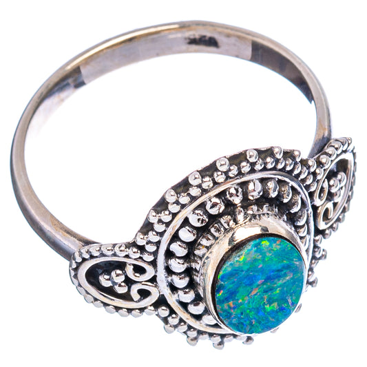 Sterling silver oval opal ring with raised bezel and detailed side filigree prongs