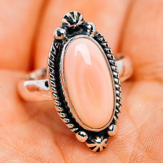 Pink oval conch shell set in .925 sterling silver ring, detailed raised border and beads