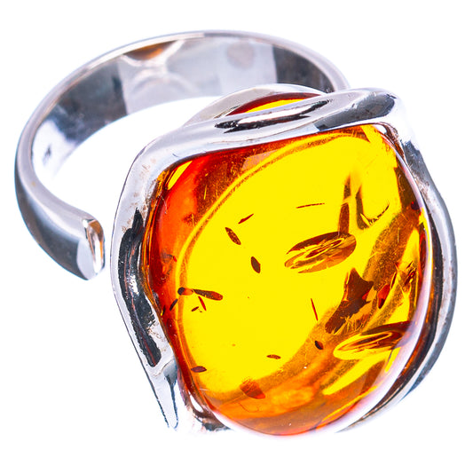 Adjustable amber and sterling silver ring with oval amber cabochon