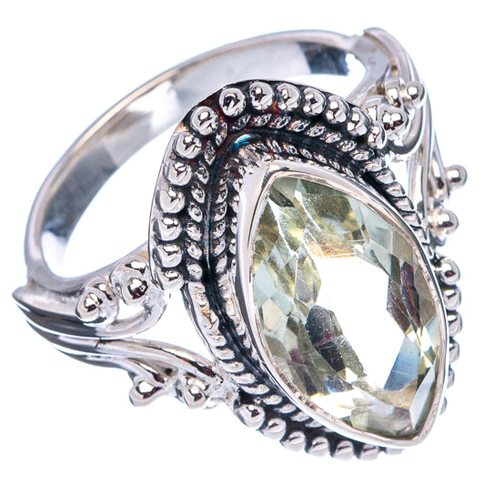 Sterling silver ring with oval greenish gemstone and ornate side filigree band