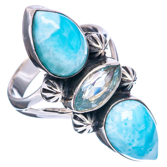 Sterling silver ring with large oval blue stone, clear center oval, and leafwork bezel