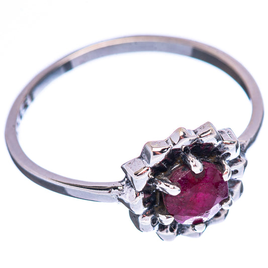 Sterling silver ring with dark red oval center stone and raised claw prongs