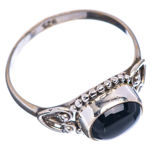 Sterling silver ring with black onyx in oval bezel, side view with raised shoulders
