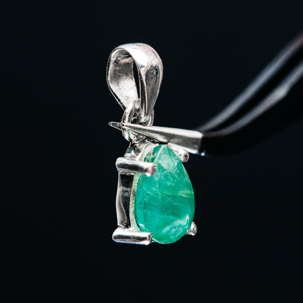 Sterling silver emerald pendant with pear-shaped green stone and loop bail