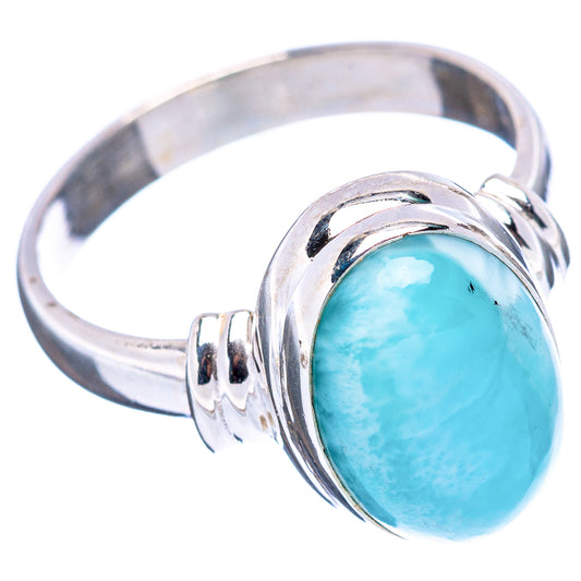 Sterling silver ring with oval blue cabochon and swirl bezel setting