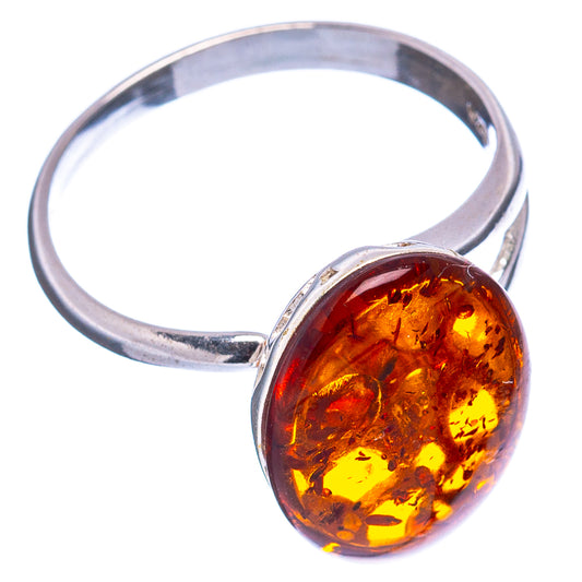 Amber cabochon setting on open silver band, round dark orange