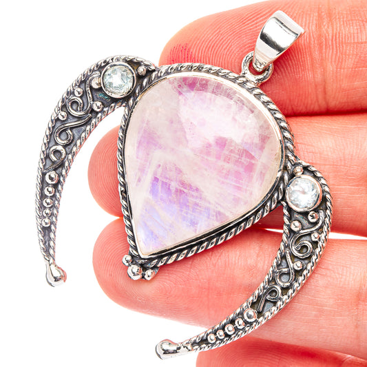 Rainbow moonstone pendant with purple-pink sheen, silver filigree and blue stones