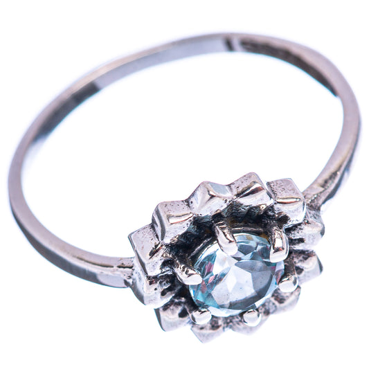 Sterling silver ring band with round light-blue gemstone in textured floral prongs