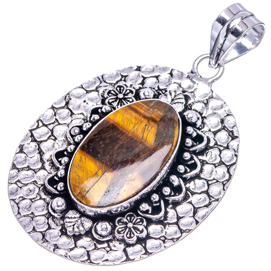 Silver-toned tiger's eye oval pendant, textured bezel with floral accents and loop bail
