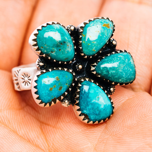 Turquoise oval cluster ring on silver band with black accents