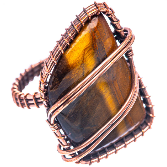 Oxidized copper wire ring, side view with tiger-eye striped oval gemstone and wrapped setting