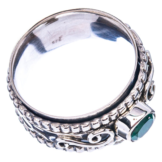 Sterling silver ring with oval green gemstone and ornate patterned band