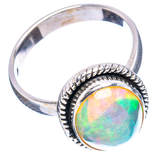 Oval opal ring with iridescent rainbow stone, rope-textured bezel, silver band