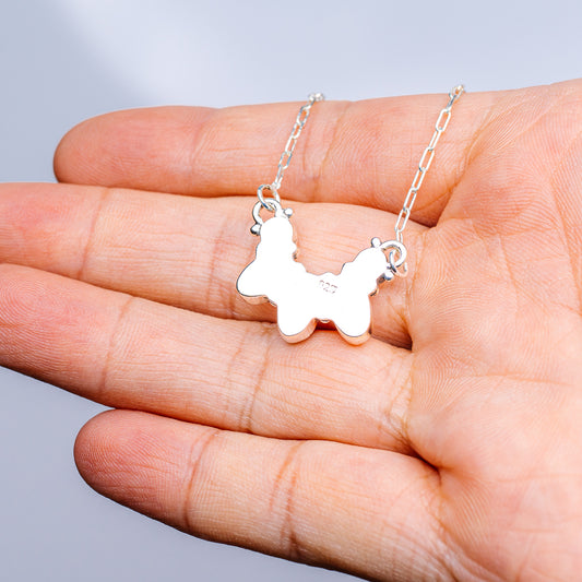 Turquoise necklace with openwork animal-shaped pendant on sterling silver chain