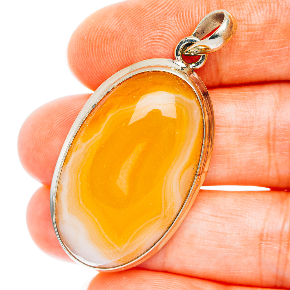 Oval orange agate pendant with white marbling, German silver bezel and loop bail