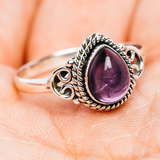 Oval amethyst ring in .925 sterling silver, twisted border and decorative side scrolls