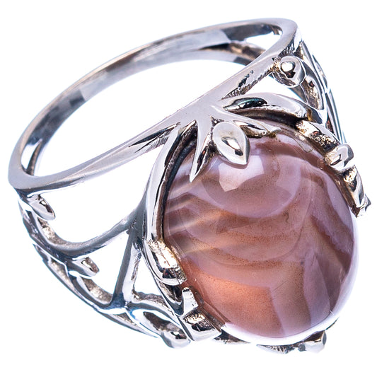 Sterling silver ring showing oval Botswana agate cabochon in openwork swirl band