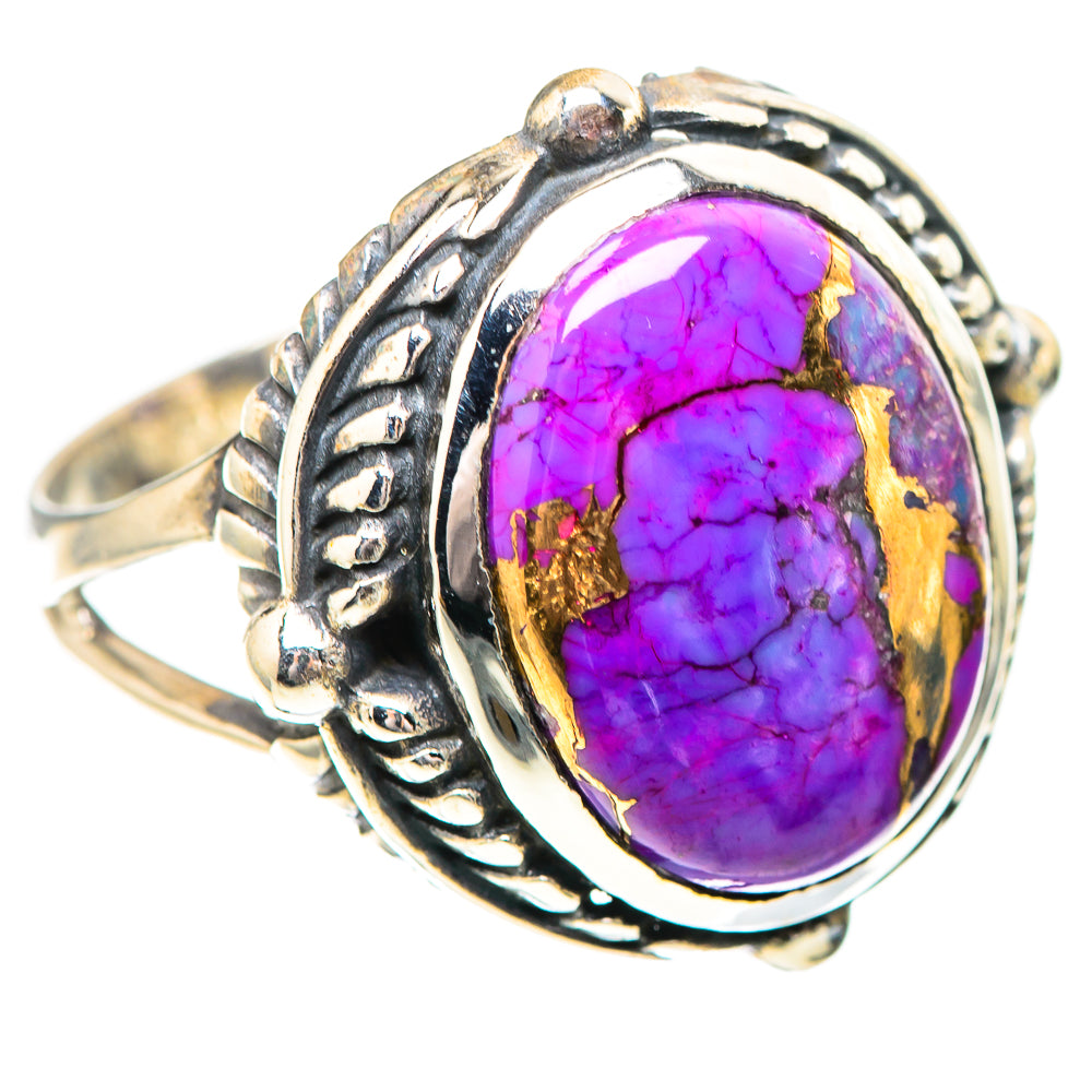 Sterling silver ring featuring oval purple turquoise cabochon, gold accents, detailed side band