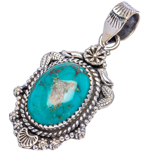 Turquoise oval cabochon pendant in etched sterling silver frame with flower bail