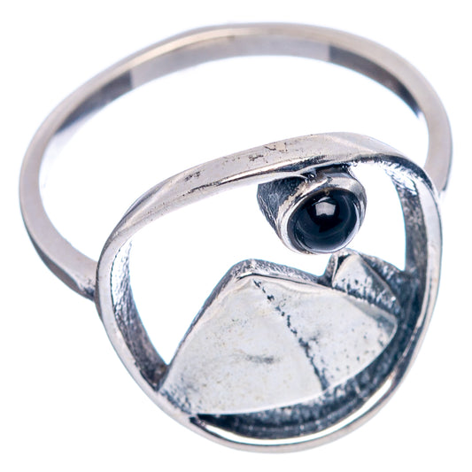 Sterling silver ring with mountain texture and dark blue cabochon in oval bezel