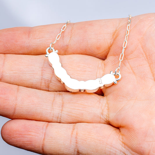 Sterling silver gemstone necklace with oval green stones and toggle clasp on chain.