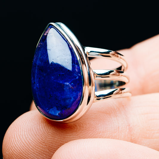 Sterling silver oval tanzanite cabochon ring with deep blue gemstone, angled view