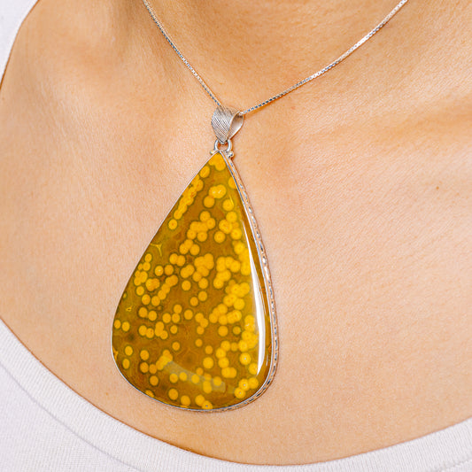 Ocean jasper teardrop pendant on silver chain, amber yellow mottled stone
