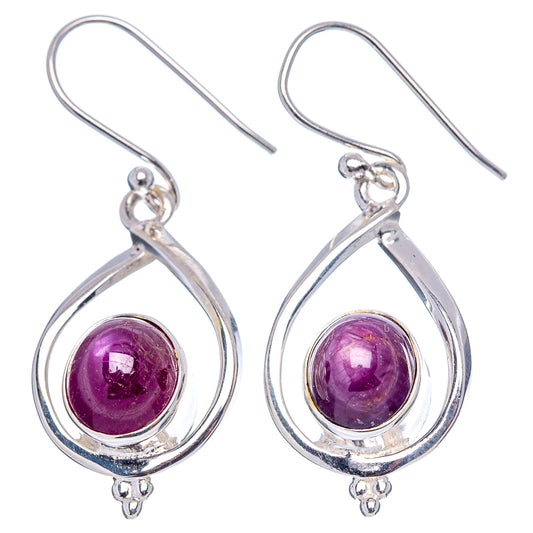 Sterling silver drop earrings with purple star ruby cabochon in teardrop settings