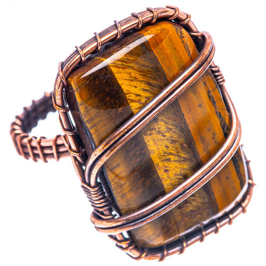 Amber tiger's eye ring with oxidized copper wire frame, angled full view