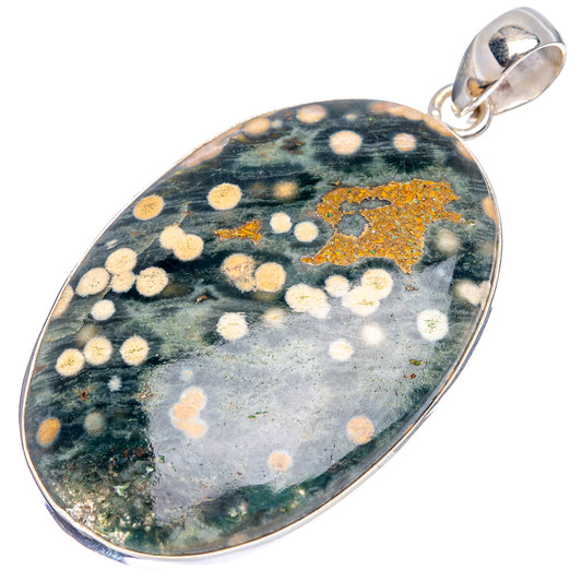 Ocean jasper pendant in oval sterling silver bezel with green and gold dotted pattern.