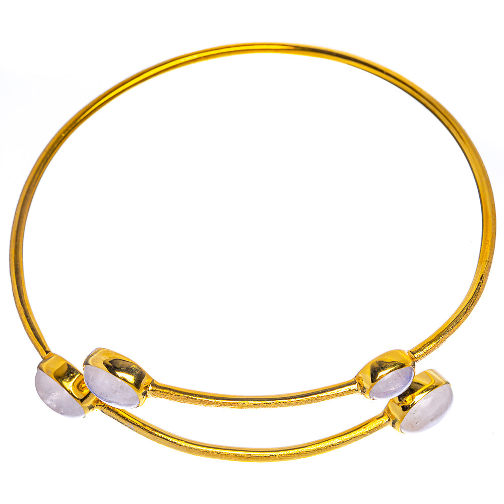 Gold-tone open cuff bracelet front view with oval moonstone cabochons